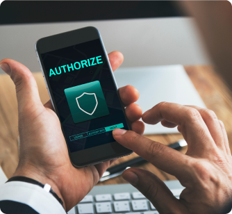 A close-up of a person's hands holding a smartphone and pressing an "AUTHORIZE" button on a screen featuring a shield security icon.