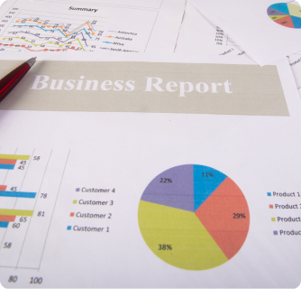A printed business report featuring various colorful pie charts and bar graphs on a desk.